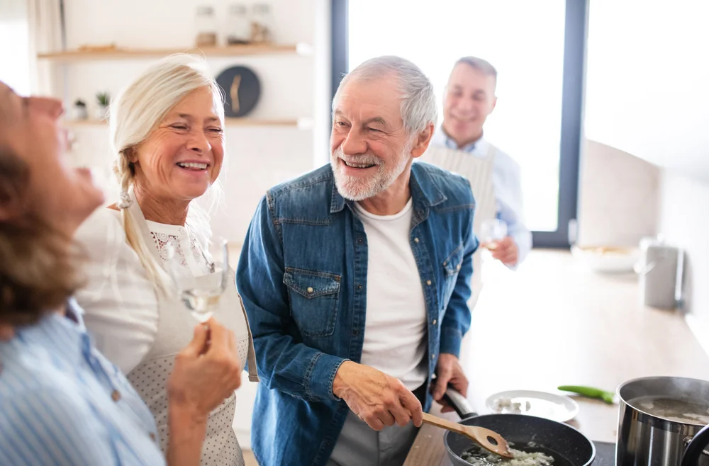 Group of seniors cooking and laughing together