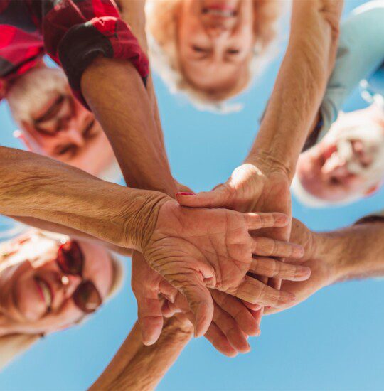 hands on top of each other with faces looking through