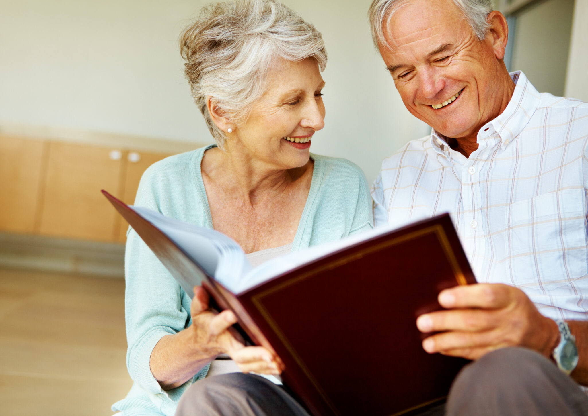 Senior couple looking at photo book together