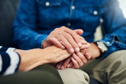 senior holding his senior wife's hands in his