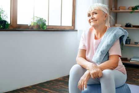 senior woman sits on an exercise ball