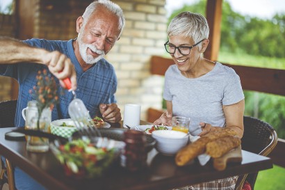 senior couple eating a meal outside together 