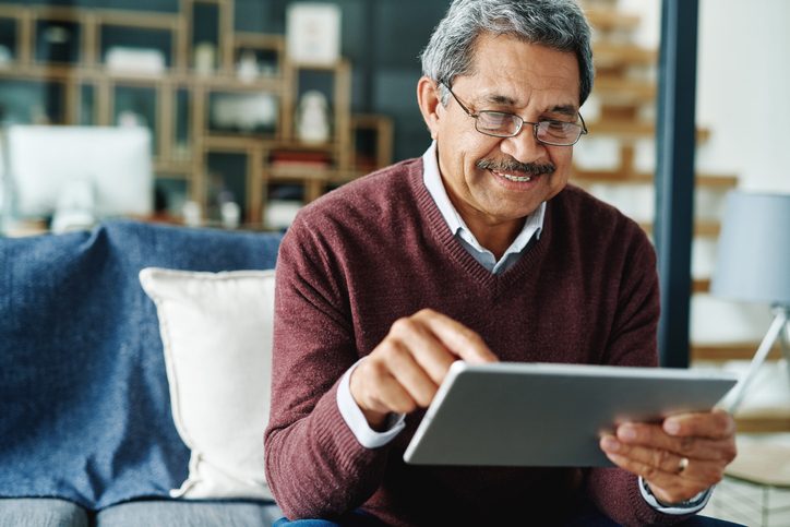 a senior man using a tablet