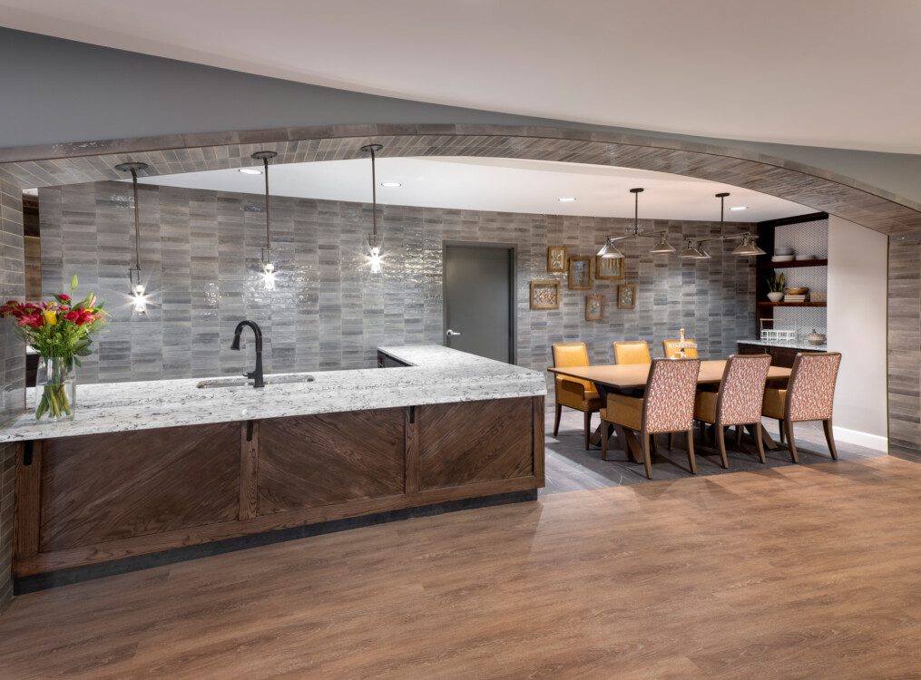 elegant and modern community dining nook and kitchen area at Querencia Senior Living Community's Assisted Living Building