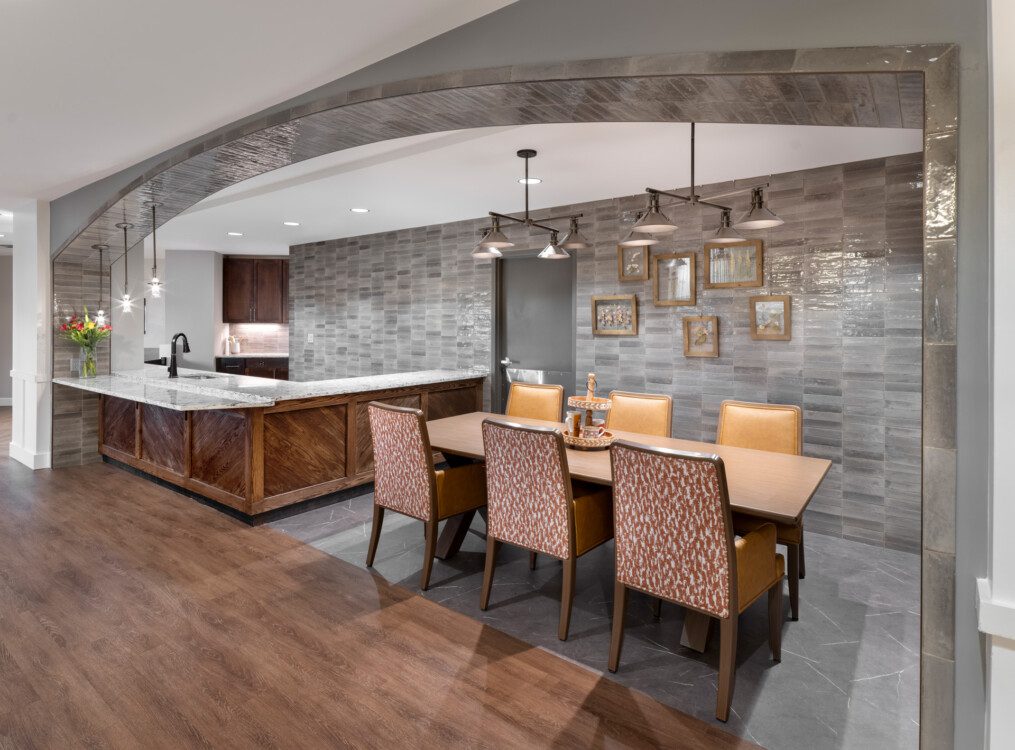 elegant and modern community dining nook and kitchen area at Querencia Senior Living Community's Assisted Living Building