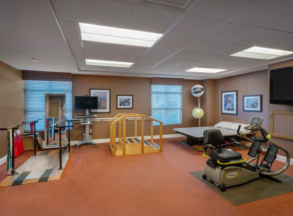 Well-equipped senior physical rehabilitation gym at Querencia's Assisted Living building