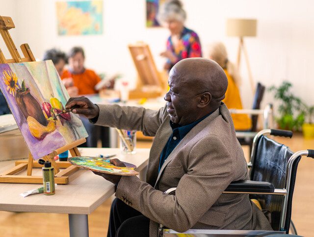 Resident painting in community art class.