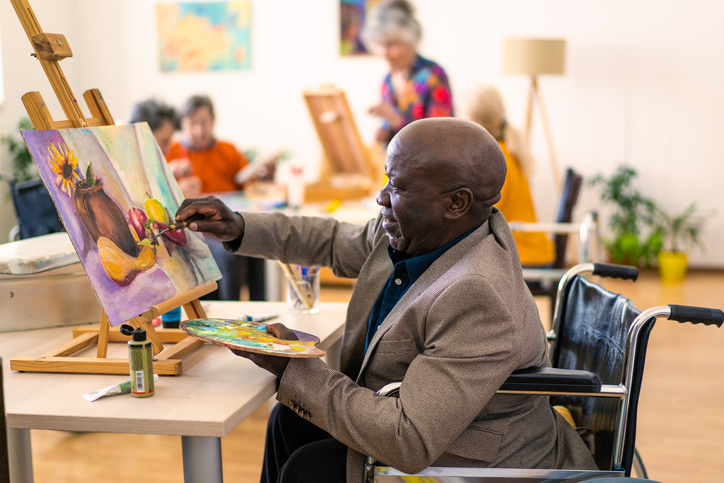 Resident painting in community art class.