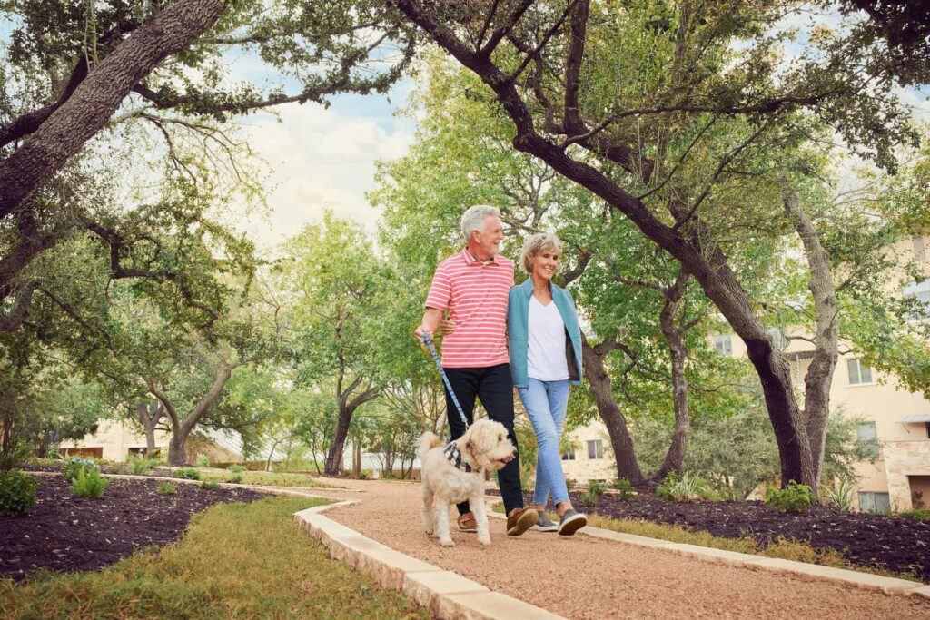 ouple walking a dog outside